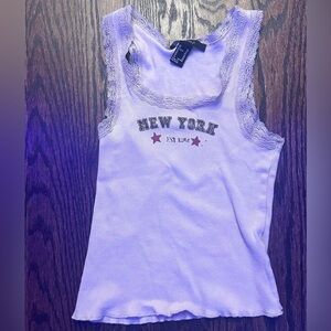 tan tank top with new york graphic on it